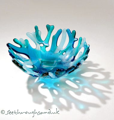Hand crafted fused glass reflecting coral branches.